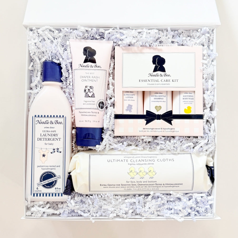 Gift set with bath products and stationery items on a textured surface