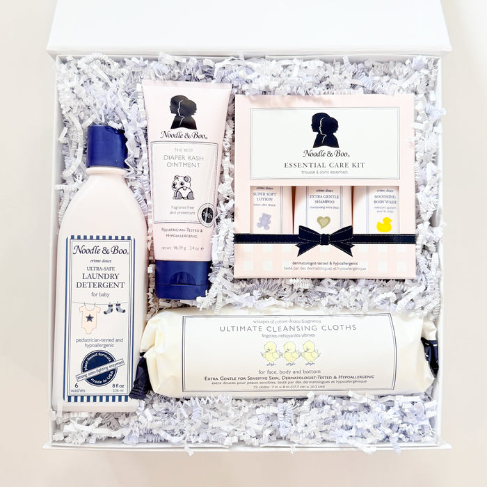 Gift set with bath products and stationery items on a textured surface
