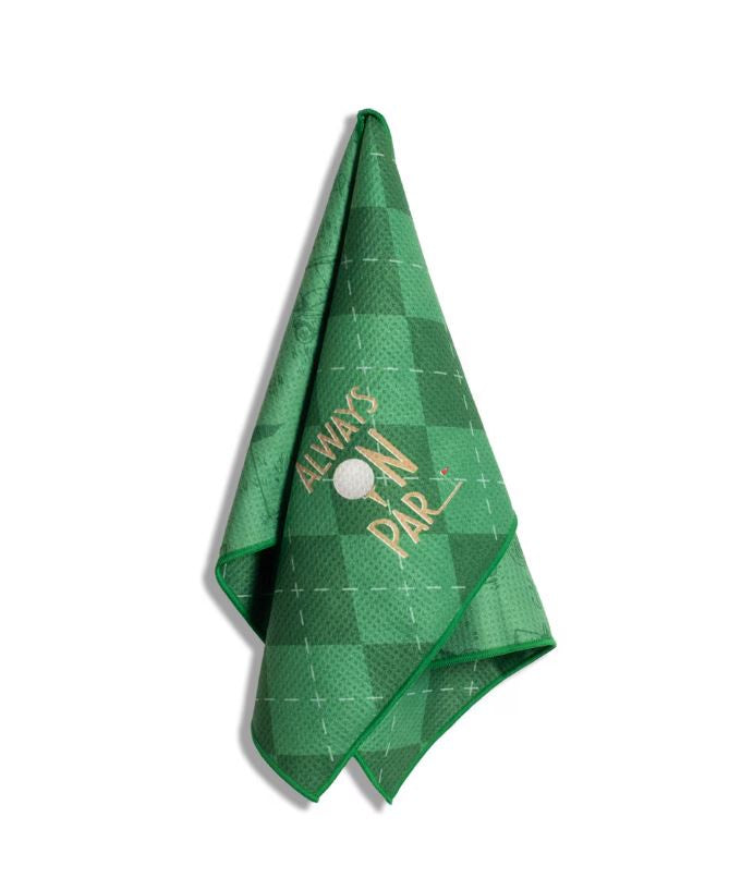 Waffle-textured microfiber golf towel displayed on a white background featuring a green checkered pattern, thin white grid lines, the embroidered slogan Always On Par, a white golf ball, and a tiny red flag pin