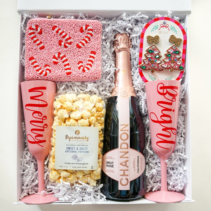 Gift set with champagne, popcorn, and festive items in a box