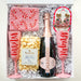 Gift set with champagne, popcorn, and festive items in a box