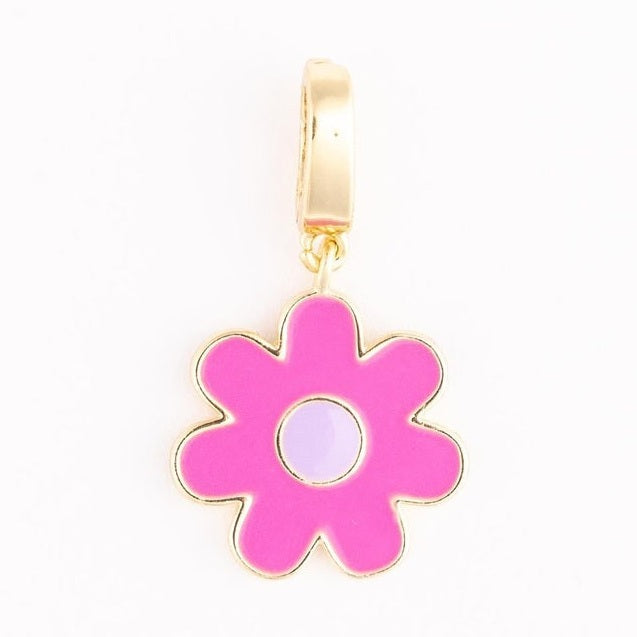 Gold-plated enamel jewelry charm of a stylized flower centered on a white background featuring seven vibrant pink petals, a pale lavender center, and a polished metallic bail