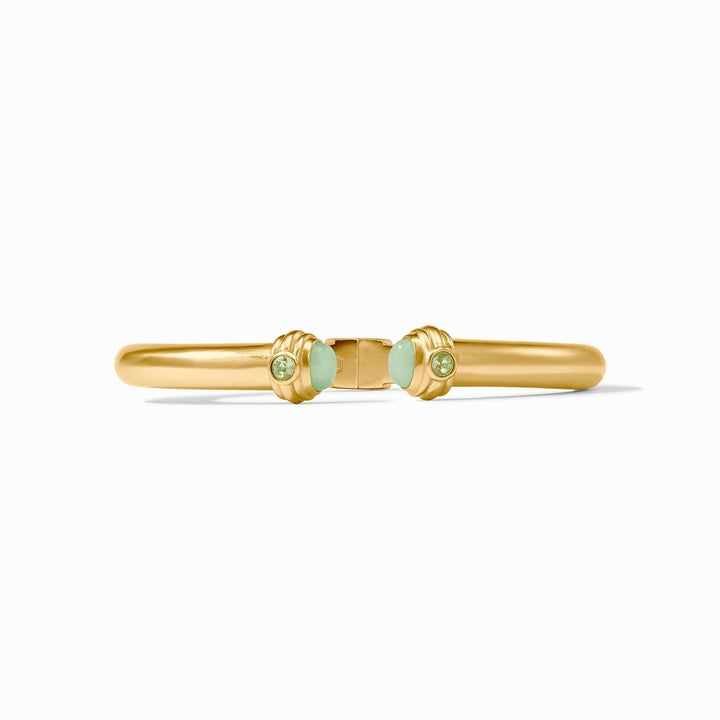 24k gold plated bangle by Julie Vos centered on a white background featuring a hinged gold band with textured ribbed finials, smooth mint green cabochons, and sparkling peridot green faceted stones