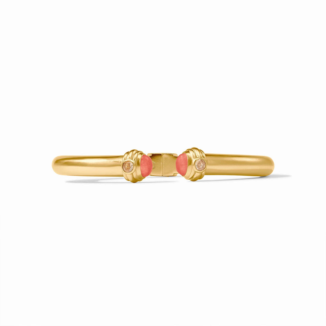 24k gold-plated brass bangle by Julie Vos featuring a hinged golden band centered on a white background with fluted end caps, vibrant pink cabochon stones, and shimmering clear crystals