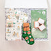Gift box with socks, a card, and other items on a white background