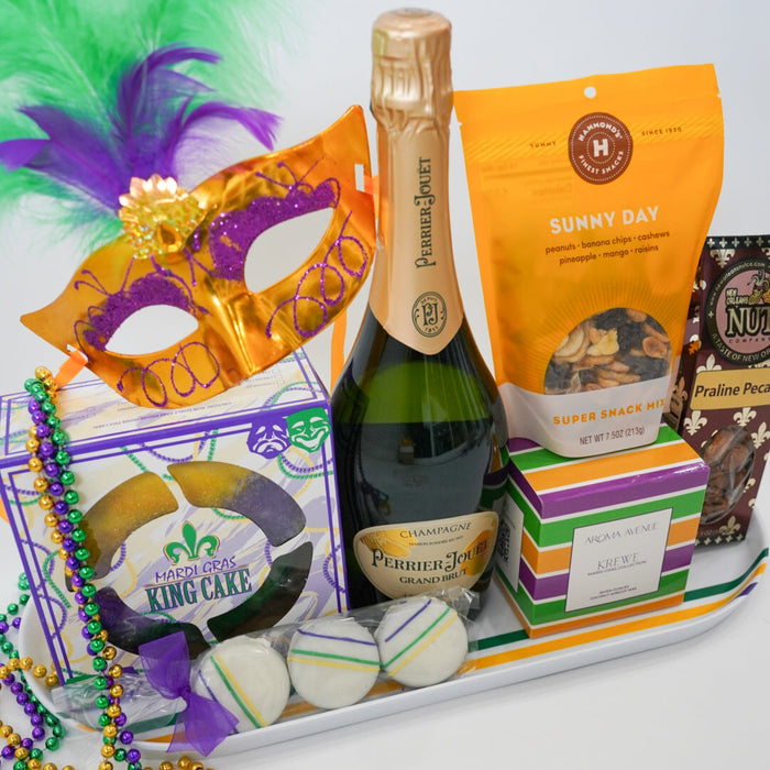 Mardi Gras-themed gift basket with champagne, snacks, and a mask on a white background