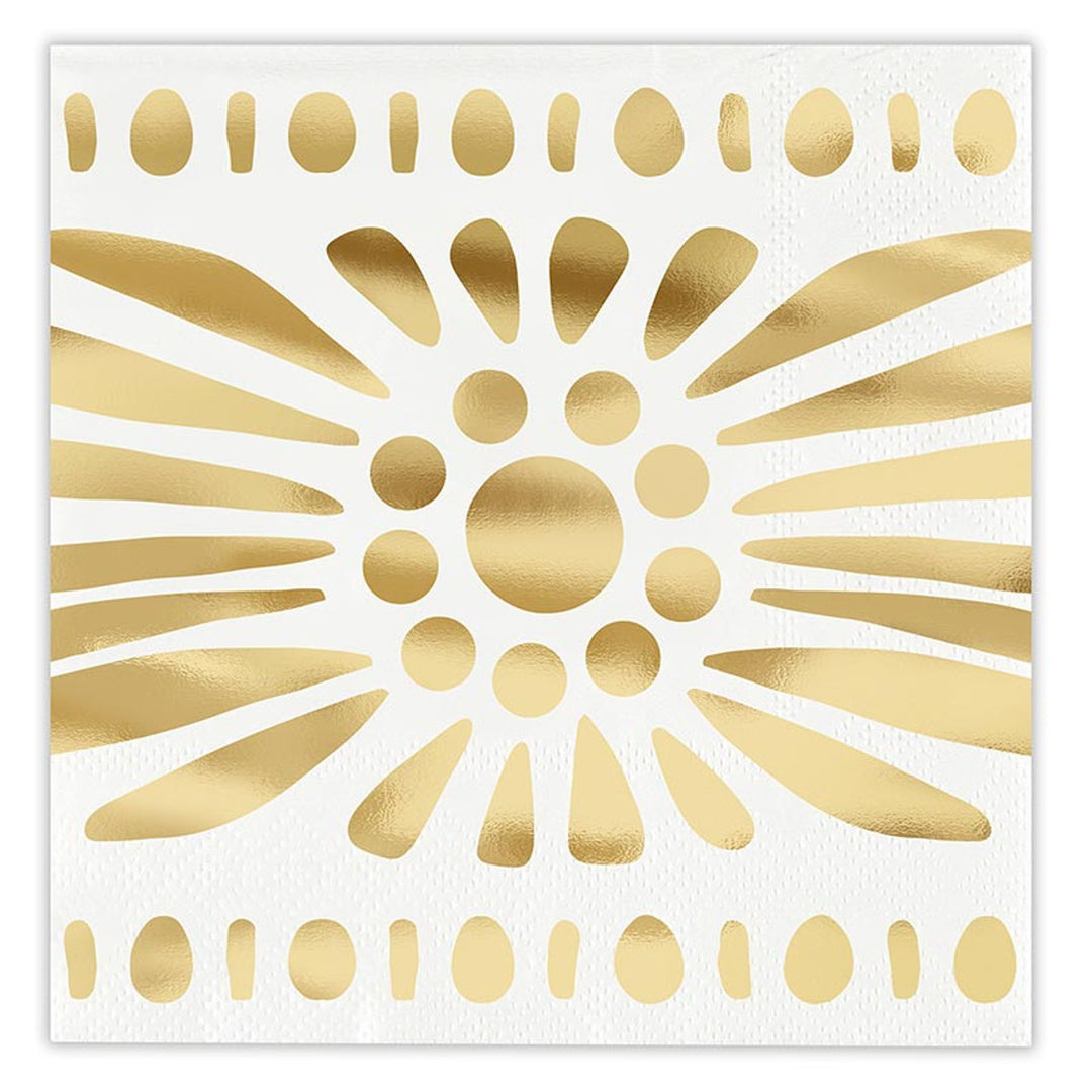 Gold foil graphic on white textured paper napkin featuring a central abstract sunburst motif with radiating metallic teardrop shapes and horizontal borders of alternating golden ovals and dots