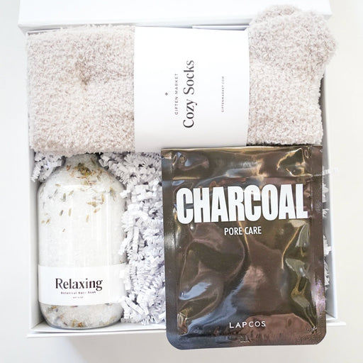 Set of Cozy Socks with Charcoal Pore Care Pack and Relaxing Bath Salts in a box on a white background