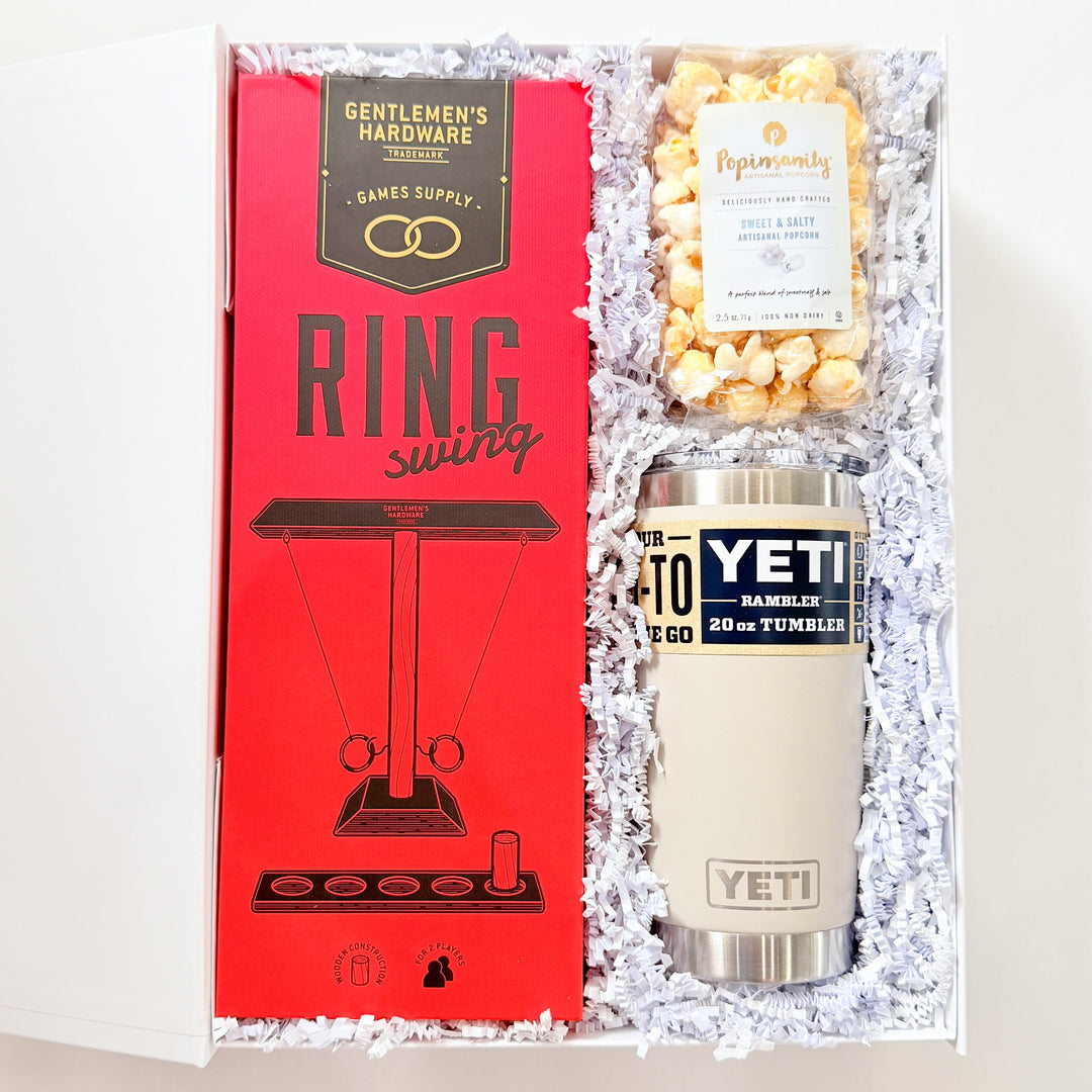 Gift set with YETI tumbler, popcorn, and 'Gentlemen's Hardware' box on a white background