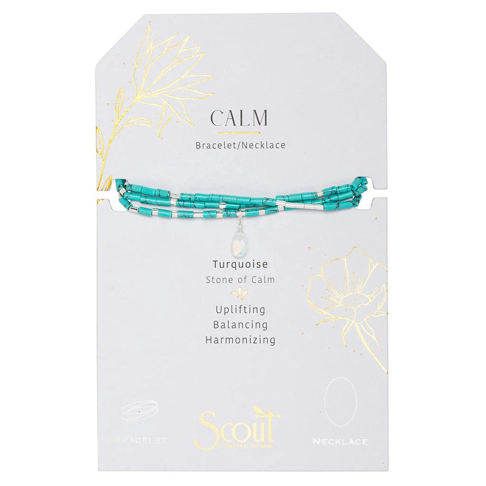 Jewelry by Scout Curated Wear featuring a triple-strand turquoise wrap bracelet on a white display card with gold foil floral illustrations and a faceted white stone charm with silver tube beads