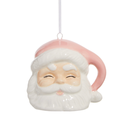 Ceramic Christmas ornament of a vintage Santa Claus face hanging from a white ribbon featuring a pastel pink hat, rosy cheeks, and a glossy white beard