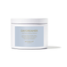 Studio photograph of a Moodcast Fragrance Co. Daydreamer candle featuring a white ceramic jar with a light blue label and gold metallic lettering listing notes of neroli flower and white tea against a white background