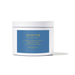 Studio photograph by Moodcast Fragrance Co of the Jetsetter scented candle featuring a white jar with a slate blue label, gold-toned typography, and a subtle cast shadow on a minimalist white background
