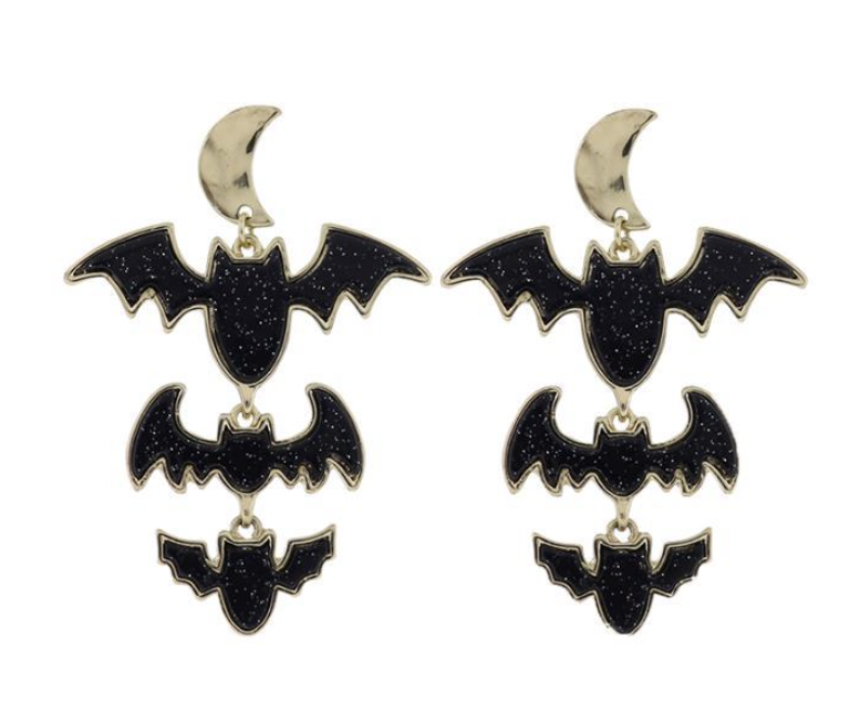 Gold-tone metal and glitter enamel earrings featuring a golden crescent moon above three tiered bats of descending size with a sparkly black finish and gold-plated outlines on a white studio background