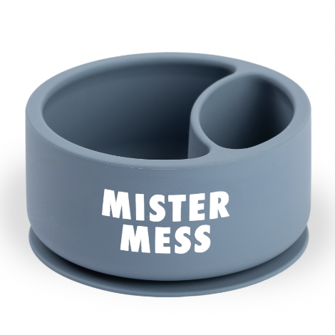 Silicone baby bowl by Mister Mess showcases a matte dusty blue divided feeding dish on a white background featuring a round suction base and bold white block lettering
