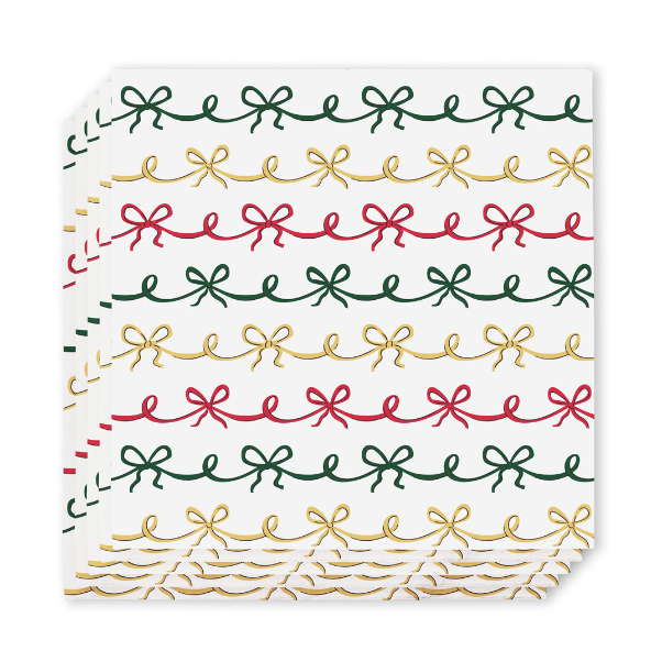 Stack of white cocktail napkins with rows of green, gold and red bows