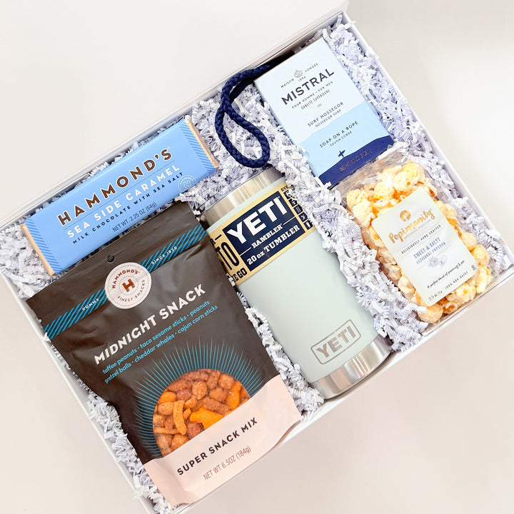 Gift set with snacks, a mug, and a box labeled &