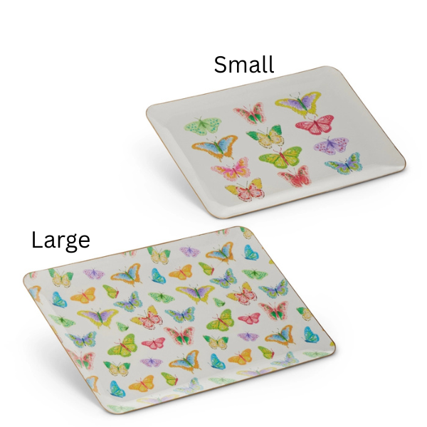 Illustrated melamine serving trays featuring vibrant watercolor butterflies in shades of pink, yellow, and blue arranged in grid and scattered patterns on a white background with gold-rimmed edges labeled small and large