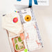 Baby gift set with burp cloth, bib, and box on a white background