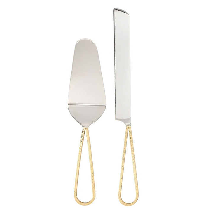 Polished stainless steel cake serving set featuring a server and serrated knife with elegant hammered gold-tone teardrop handles against a minimalist white background