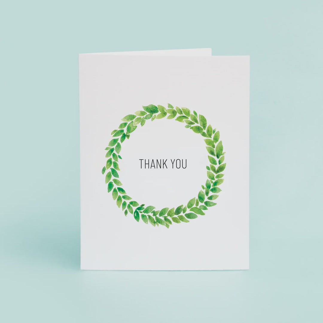 White greeting card with a green leaf wreath and the words Thank You