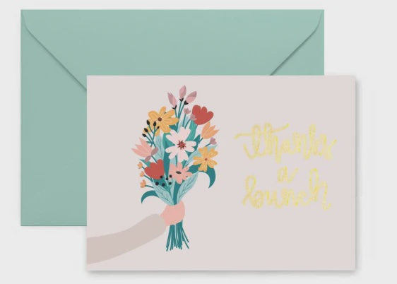 Illustrated greeting card depicting a hand holding a colorful wildflower bouquet with a mint green envelope and elegant gold script lettering that says thanks a bunch