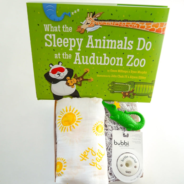Children's book titled 'What the Sleepy Animals Do at the Audubon Zoo' with a baby product package on a white background