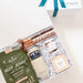 Gift set with beef jerky, Yeti mug, and other items on a white background