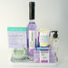 Collection of skincare and wellness products on a white tray with a white background