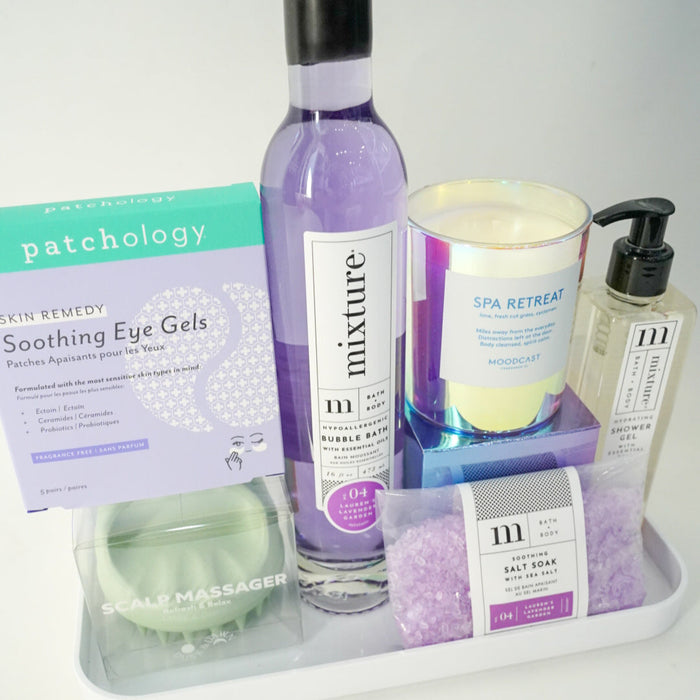 Collection of skincare and wellness products on a tray with a white background