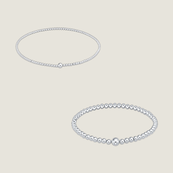 Professional jewelry photography of two sterling silver beaded bracelets on a white background featuring polished spherical beads of varying diameters and a single larger central focal bead on each strand