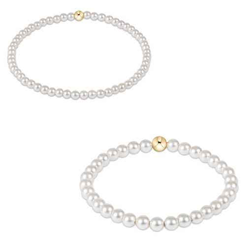 Two pearl necklaces with gold clasps on a white background