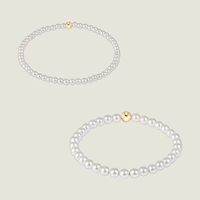 Two pearl necklaces with gold clasps on a white background