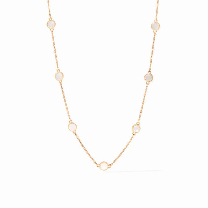 Yellow gold necklace featuring iridescent circular white mother-of-pearl stations in smooth bezel settings along a delicate link chain centered against a minimalist white background