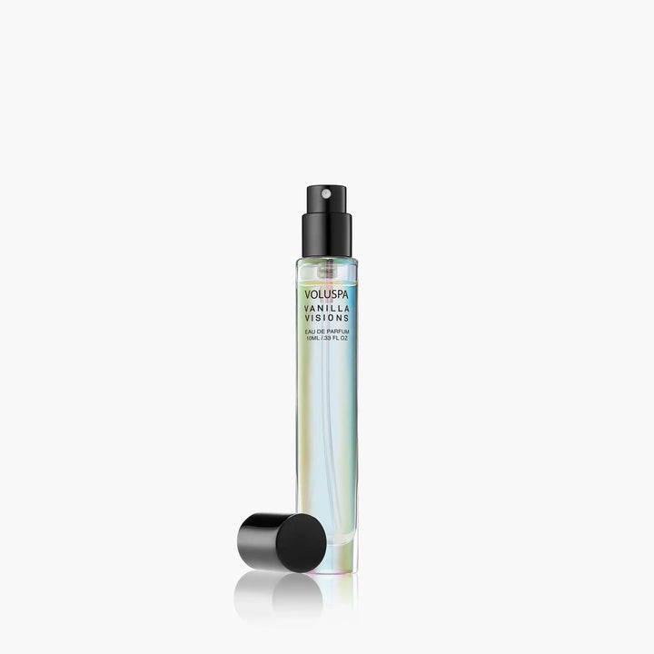 Product photography by Voluspa of a Vanilla Visions Eau de Parfum travel spray bottle on a white background featuring iridescent holographic glass, a black spray nozzle, and a detached black cap