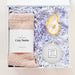Gift set with socks, bath bomb, and candle in a box on a white background