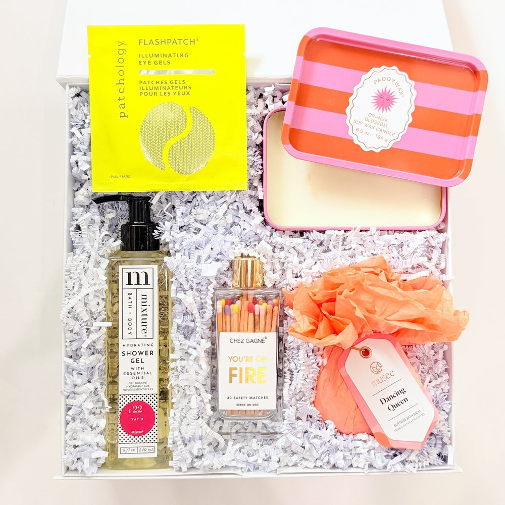 Set of skincare products including bottles, a pouch, and a box on a white background