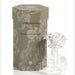 Product photography of an Aromatique Grand Casablanca fragrance diffuser set featuring a hexagonal taupe damask-patterned gift box and a clear glass bottle topped with a delicate white ceramic rose flower
