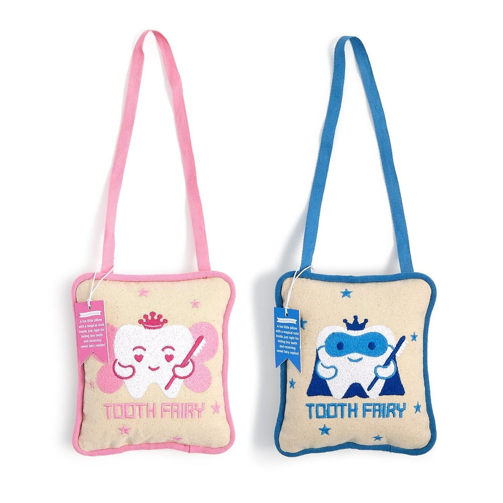 Embroidered cotton canvas pillows by Mud Pie featuring two hanging tooth fairy door hangers on a white background, showcasing a pink winged fairy tooth and a blue masked superhero tooth, both adorned with royal crowns and holding star wands