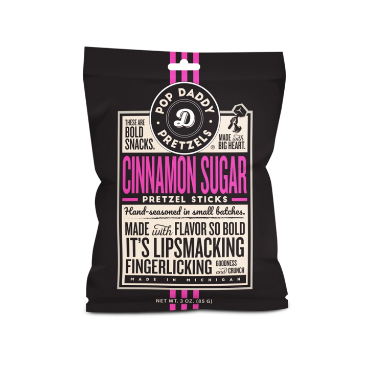 Graphic design for Pop Daddy Pretzels of a snack bag for Cinnamon Sugar Pretzel Sticks from Michigan featuring vibrant pink typography, a circular white logo, and vertical pink stripes on a black background