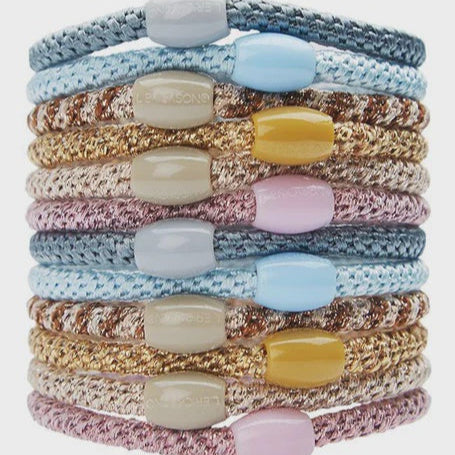 Stack of twelve braided metallic hair ties in blue, gold, tan and pink with matching beads