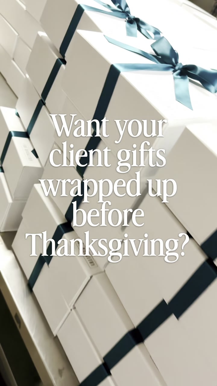 Stacks of white Basketry gift boxes tied with teal ribbon.