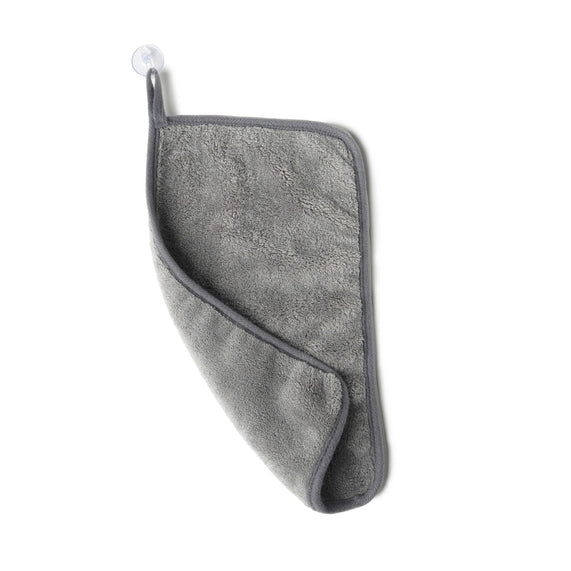 Studio photograph of a grey microfiber towel hanging against a white background featuring a clear suction cup, an integrated fabric loop, and a soft plush texture with a folded corner