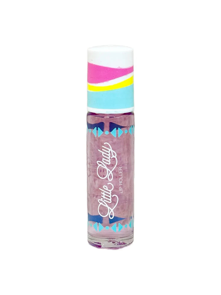 Product photograph of a Little Lady Lip Roller against a white background featuring a colorful cap with pink and yellow wavy stripes, a clear tube of purple translucent liquid, and blue geometric patterns framing the white cursive logo