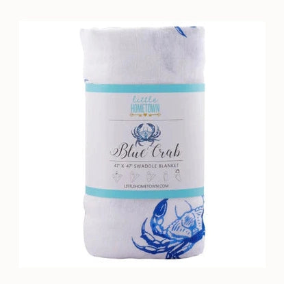 Muslin swaddle blanket by Little Hometown featuring an iconic Maryland blue crab design on white fabric with vibrant blue illustrations and a teal-accented product label