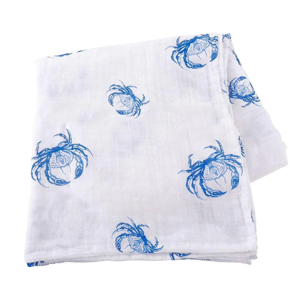Printed cotton muslin baby swaddle blanket featuring a repeating pattern of detailed cerulean blue crabs with sharp pincers and textured legs on a folded white background