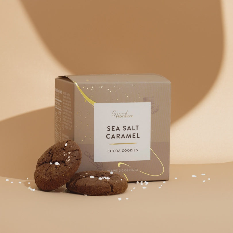 Gray Grand Provisions Sea Salt Caramel cocoa cookies box with two chocolate cookies beside it