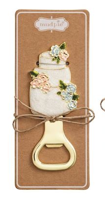 Enamel and gold-tone metal bottle opener by Mud Pie featuring a three-tiered white wedding cake accented with pastel pink and blue flowers on a kraft display card tied with a jute twine bow
