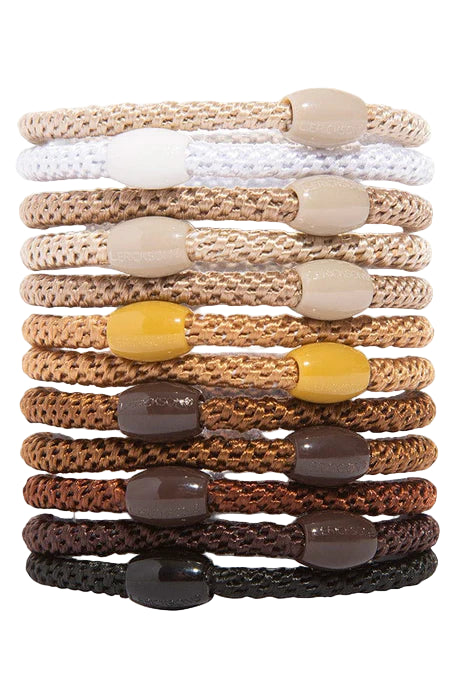 Stack of twelve braided hair ties in neutral shades from white and beige to brown and black