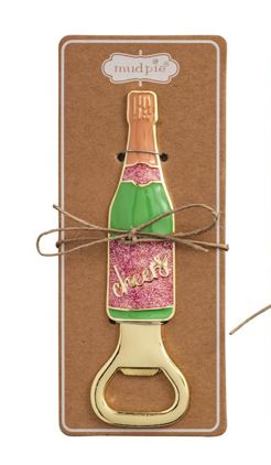Mud Pie metal bottle opener shaped like a champagne bottle on a cardboard mount featuring the Mud Pie logo, pink glitter accents, and gold cursive Cheers script
